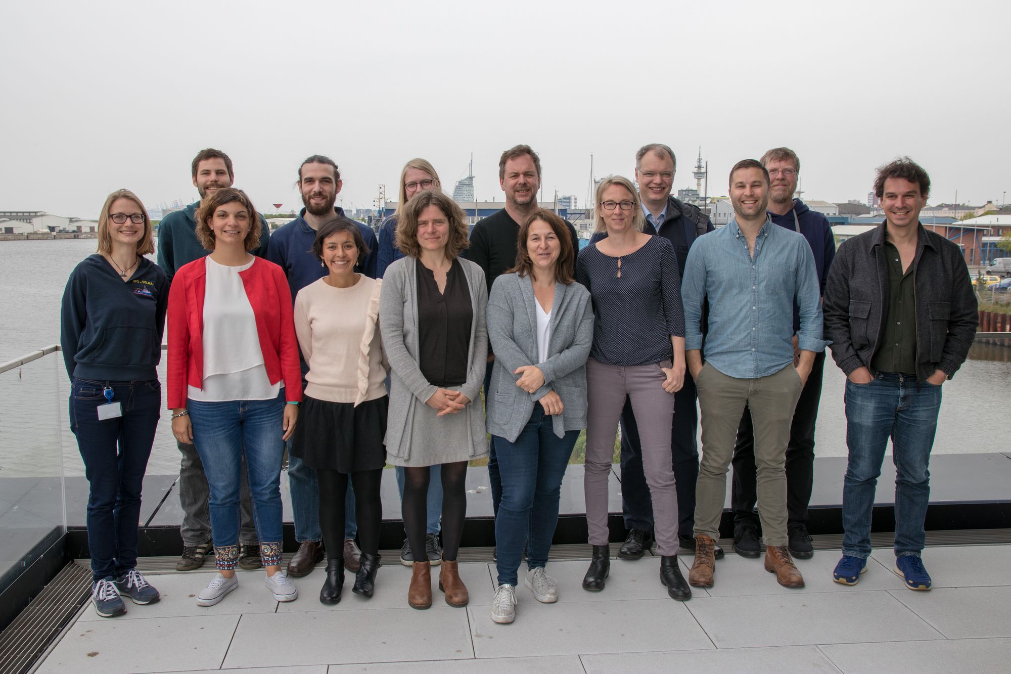 The 14 project collaborators in 2 rows in front of Bremerhaven harbour